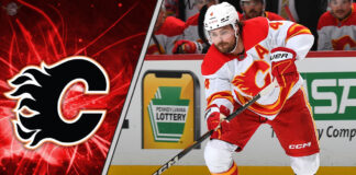 Calgary Flames defenseman Rasmus Andersson looks on during an NHL game, with NHL trade rumors circulating about his future with the team.