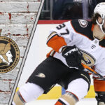 Rift in Anaheim? Senators Eyeing Trade for Mason McTavish An action shot of Mason McTavish in his Anaheim Ducks jersey, skating with the puck during an NHL game, with the Ottawa Senators logo in the corner.