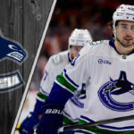Vancouver Canucks defenseman Quinn Hughes skates with the puck, quarterbacking the power play during an NHL game.