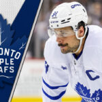 Auston Matthews getting ready for a face-off with the Leafs logo to the left