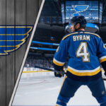 Bowen Byram in a St. Louis Blues jersey at center ice of the Enterprise Center