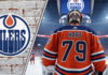 Close-up of goalie Carter Hart looking focused, with an Edmonton Oilers logo faded in the background, representing the latest NHL trade rumors.