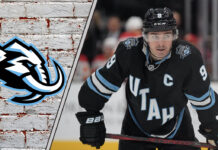 A focused Clayton Keller of the Utah Mammoth skates with the puck during an NHL game, poised for a breakout season.