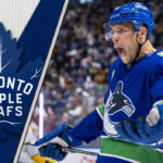 The Leafs Finally Added Grit, But Dakota Joshua is More Than Just a Tough Guy Dakota Joshua, in his Vancouver Canucks jersey, skates during an NHL game, embodying the physical presence he is set to bring to the Toronto Maple Leafs.