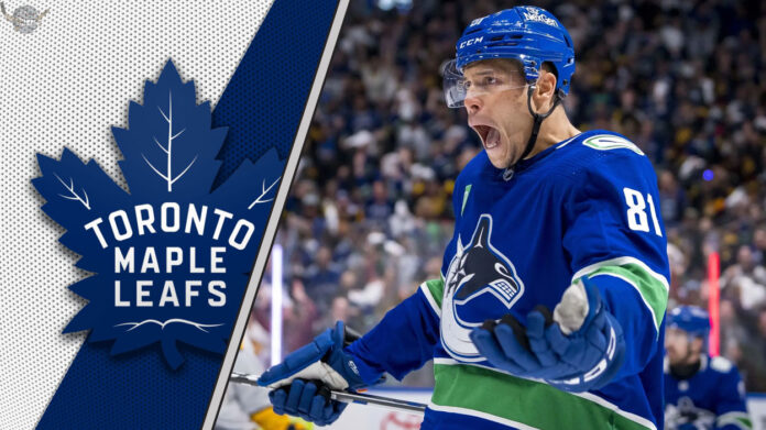 Dakota Joshua, in his Vancouver Canucks jersey, skates during an NHL game, embodying the physical presence he is set to bring to the Toronto Maple Leafs.