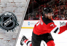New Jersey Devils defenseman Dougie Hamilton skates with the puck during an NHL game, with "Dougie Hamilton Rumors" text overlay.