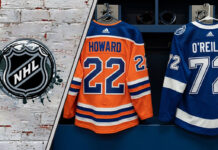 The backs of Isaac Howard's #22 Edmonton Oilers jersey and Sam O'Reilly's #72 Tampa Bay Lightning jersey hang side-by-side in an NHL locker room stall, symbolizing the recent trade.