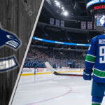 Jack Roslovic to the Canucks? The Rumors Are Heating Up A hockey player wearing a Vancouver Canucks jersey with the name Roslovic and the number 96 on the back, standing at center ice.