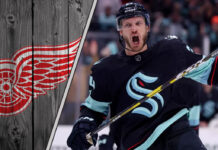 Seattle Kraken defenseman Jamie Oleksiak skates during an NHL game, amid growing trade rumors linking him to the Detroit Red Wings.