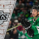 Dallas Stars forward Jason Robertson skates with the puck during an NHL game, with rumors of a potential trade to the LA Kings in the background.