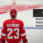 Lucas Raymond Point Projections 2025-26: The Making of a Fantasy Hockey Superstar Detroit Red Wings forward Lucas Raymond stands at center ice with a graphic overlay detailing his 2025-26 point projections for the upcoming NHL fantasy season.