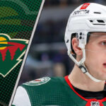 Is a Rival GM About to Force the Wild’s Hand on Marco Rossi? Minnesota Wild center Marco Rossi skates with the puck during an NHL game, looking focused amid ongoing contract negotiations.