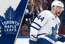 Toronto Maple Leafs defenseman Morgan Rielly looks on during a game, amidst swirling NHL trade rumors about his future.
