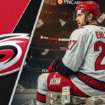 Nikolaj Ehlers in a Carolina Hurricanes jersey sitting on money at PNC Arena after signing a new contract.
