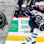 Winnipeg Jets forward Nikolaj Ehlers skates with the puck during an NHL game, looking for a passing lane.