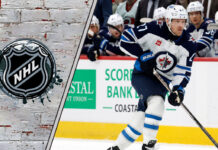 Winnipeg Jets forward Nikolaj Ehlers skates with the puck during an NHL game, looking for a passing lane.