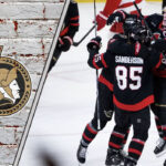 Ottawa Senators team celebrating a goal with the logo over-layed to the left on the image