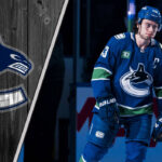 Quinn Hughes to Devils Rumors: What’s Really Going On? Vancouver Canucks defenseman Quinn Hughes skates with the puck during an NHL game, with a graphic overlay of the Canucks logo.