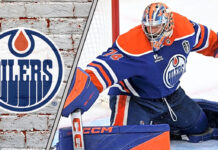 Edmonton Oilers goalie Stuart Skinner looks on during a game, focused and ready for action.