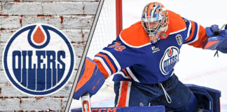 Edmonton Oilers goalie Stuart Skinner looks on during a game, focused and ready for action.