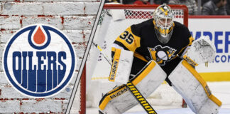 Pittsburgh Penguins goalie Tristan Jarry in his gear, looking on during a game, amidst recent NHL trade rumors linking him to the Edmonton Oilers.