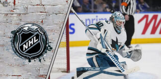 Alexandar Georgiev in his San Jose Sharks jersey, looking focused during a game, with the crowd blurred in the background.