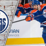 Evan Bouchard in an Edmonton Oilers jersey, taking a slap shot on the power play, emphasizing offensive skill and point production for 2025-26.