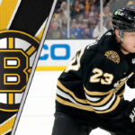 Boston Bruins forward Fabian Lysell skates with the puck during an NHL game, with the Boston Bruins logo visible in the background, representing the latest on Boston Bruins rumors.