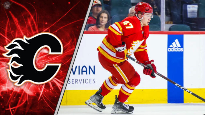 Calgary Flames forward Connor Zary skating with the puck during an NHL game, looking determined