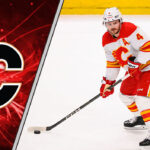 Calgary Flames defenseman Rasmus Andersson skates with the puck during an NHL game