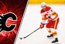 Calgary Flames defenseman Rasmus Andersson skates with the puck during an NHL game