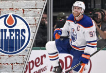 Edmonton Oilers captain Connor McDavid skating in his jersey, celebrating a goal during a game.