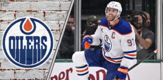 Edmonton Oilers captain Connor McDavid skating in his jersey, celebrating a goal during a game.