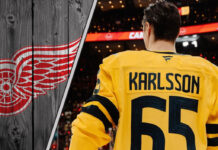Pittsburgh Penguins forward Erik Karlsson standing on the ice with the Detroit Red Wings logo to the left as NHL trade rumors swirl around him