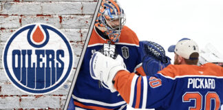 Edmonton Oilers goalies celebrating a win, with the team's logo in the background.