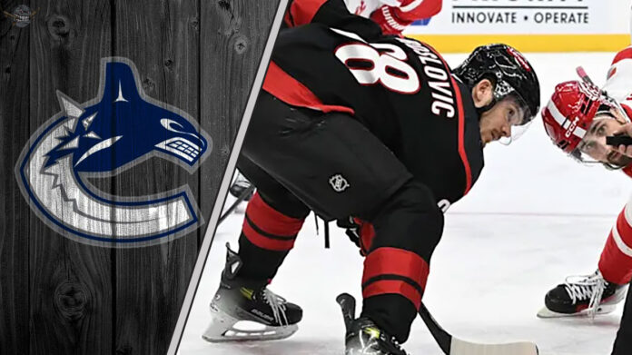 The Underrated Move That Could Redefine the Vancouver Canucks' Season An image of Jack Roslovic in a Carolina Hurricanes jersey, with the Vancouver Canucks logo in the background.