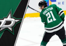 Dallas Stars forward Jason Robertson skates with the puck during an NHL game.