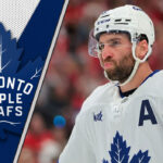 Toronto Maple Leafs captain John Tavares skates during a game, looking focused on the play.