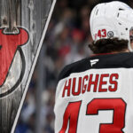 What’s Really Happening with Luke Hughes’ Contract Negotiation? New Jersey Devils defenseman Luke Hughes skating with the puck during an NHL game.