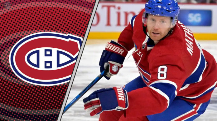 mike-matheson-rumors-habs-august-8-2025 Montreal Canadiens defenseman Mike Matheson skates with the puck during an NHL game, with NHL trade rumors swirling around his future with the team