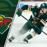 Minnesota Wild forward Marco Rossi skating with the puck during an NHL game.