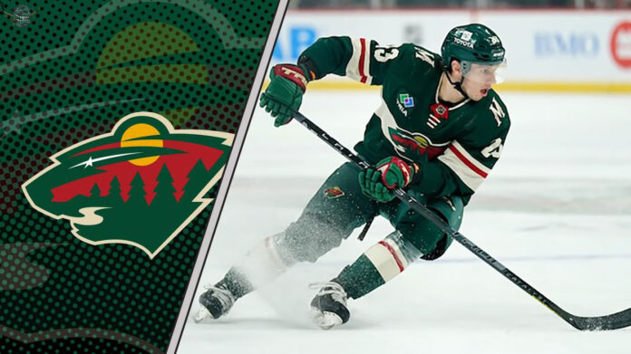Minnesota Wild forward Marco Rossi skating with the puck during an NHL game.