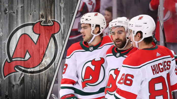New Jersey Devils star Jack Hughes skates with the puck during an NHL game.