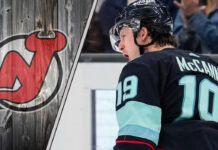 Seattle Kraken forward Jaren McCann celebrating a goal during a game with the New Jersey Devils logo to the left as NHL trade rumors swirl around him