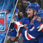 New York Rangers forwards Artemi Panarin and Alexis Lafreniere skate during a game, with the latest New York Rangers rumors suggesting a potential trade.