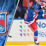New York Rangers star Artemi Panarin celebrating a goal, with the latest New York Rangers rumors about his contract extension in the background