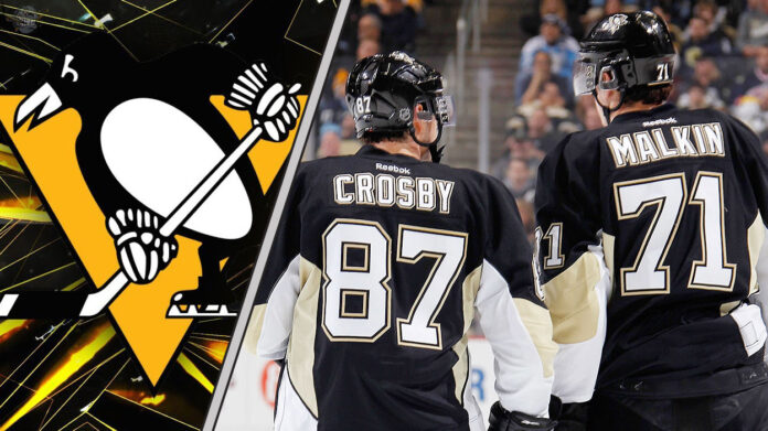 An action shot of Sidney Crosby and Evgeni Malkin skating in their Pittsburgh Penguins uniforms