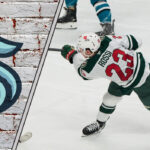 A composite image of Marco Rossi in a Minnesota Wild jersey and the Seattle Kraken logo, implying about the latest NHL trade rumors