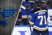 The St. Louis Blues Have a Prospect Problem… And the Trade Solution Might Surprise You St. Louis Blues forward Mathieu Joseph talking to his teammates, symbolizing the internal competition for roster spots amidst NHL trade rumors