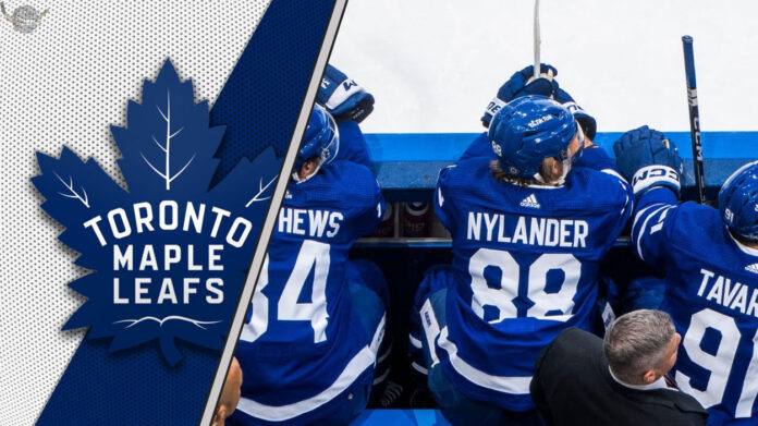 Toronto Maple Leafs forwards sit on the bench looking intense during an NHL game, representing the team's new physical identity